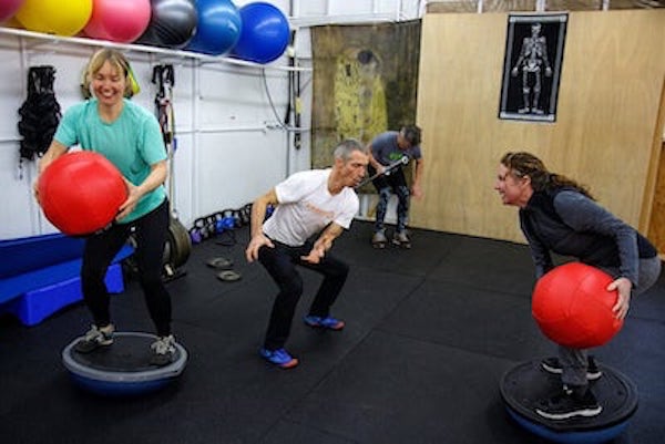 Adam Fawcett in group fitness training with three clients